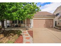 Charming single-Gathering home featuring a cozy front porch, two-car garage, and meticulous landscaping at 19481 E 50Th Pl, Denver, CO 80249