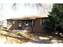 Ranch style home with mature trees and a well-maintained lawn at 1078 Elmira St, Aurora, CO 80010