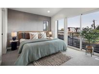 Modern bedroom features a textured accent wall, stylish decor, and a light-filled view from sliding glass doors at 1262 N Stuart St # 2, Denver, CO 80204