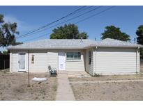 Charming single-story home featuring a well-maintained exterior and neutral-colored siding at 933 Skeel St, Brighton, CO 80601