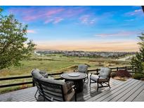 Outdoor patio with comfortable seating and expansive views of the surrounding landscape and distant neighborhood at 23030 E Del Norte Cir, Aurora, CO 80016