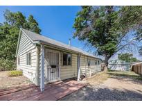 Charming single-story home with a well-maintained exterior, mature trees, and a welcoming entrance at 444 S Jersey St, Denver, CO 80224