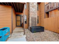 Inviting home exterior with stone chimney and well-maintained landscaped front and entrance at 9172 W 88Th Cir, Westminster, CO 80021