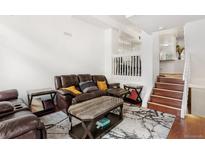 Inviting living room features a comfortable brown sofa, stylish coffee table, and sleek modern decor accents at 1885 S Quebec Way # G104, Denver, CO 80231