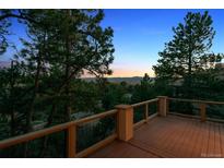 Stunning mountain views from the wooden deck with metal and wood railing at 902 Anaconda Ct, Castle Rock, CO 80108