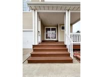 Inviting front porch with well-maintained wooden steps leading to a charming entrance at 20308 E 48Th Dr, Denver, CO 80249