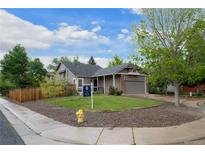 Charming single Gathering home with a well maintained lawn, mature trees, and a two car garage at 3844 S Gibralter St, Aurora, CO 80013