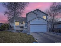 Charming two-story home featuring a two car garage, stone accents and beautifully landscaped front yard at 2482 Purcell Pl, Brighton, CO 80601