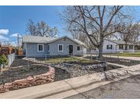 Charming single-story home features a well-manicured lawn, rock garden and inviting curb appeal at 6318 S Louthan St, Littleton, CO 80120