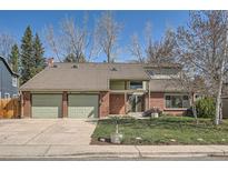 Charming two-story home with a brick facade, two-car garage and well-maintained front lawn at 6487 W Weaver Ave, Littleton, CO 80123