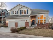 Charming two-story home boasts a two-car garage, brick accents, and inviting curb appeal in a desirable neighborhood at 781 Deer Clover Cir, Castle Pines, CO 80108