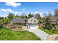 Charming two-story home with a well-manicured lawn, attached garage, and inviting curb appeal at 10743 W Turtle Mtn, Littleton, CO 80127