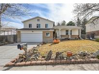 Charming two-story home featuring a well-maintained front yard and attached two-car garage at 1757 S Dearborn Way, Aurora, CO 80012