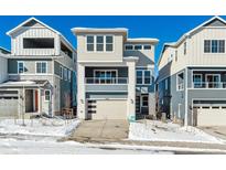 Two-story home with modern design and attached garage, snow-covered front yard at 8309 Butte Creek St, Littleton, CO 80125