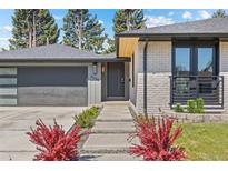 Charming front exterior with modern design elements, landscaping, and a well-maintained yard at 3049 S Vine St, Denver, CO 80210