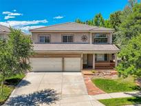 Charming two-story home featuring a well-maintained lawn, a two-car garage, and a cozy front porch at 13895 Sandtrap Cir, Broomfield, CO 80023