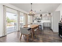 Modern kitchen and dining area with stainless steel appliances and natural light at 11048 Rifle Ct, Commerce City, CO 80022
