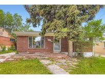 Cozy brick home featuring a mature tree in the front yard and a vintage brick porch at 4624 W Virginia Ave, Denver, CO 80219