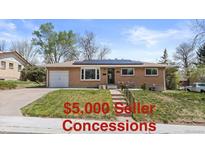 Charming brick ranch-style home featuring solar panels, a one car garage, and a well maintained lawn at 4102 W Eastman Ave, Denver, CO 80236