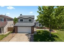 Charming two-story home featuring a well-maintained lawn and a spacious two-car garage at 455 Saddlewood Cir, Highlands Ranch, CO 80126