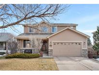 Two-story house with beige siding, stone accents, and a two-car garage at 8430 S Oak St, Littleton, CO 80127