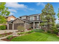 Beautiful two-story home with stone accents, lush landscaping, and a three-car garage at 24682 E Ontario Dr, Aurora, CO 80016