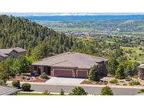 Beautiful home with a three-car garage, lush landscaping, and mountain views at 438 Galaxy Dr, Castle Rock, CO 80108