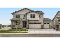 Charming two-story home with a two car garage and landscaped front yard at 98 Wooten Ave, Brighton, CO 80601
