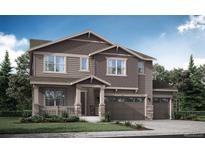 Charming two-story home with a three car garage, covered porch and professionally landscaped front yard at 98 Wooten Ave, Brighton, CO 80601