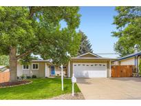 Charming single-story home boasts a well-manicured lawn and attached two-car garage at 2531 S Hoyt Ct, Lakewood, CO 80227