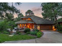 Stunning home featuring a unique roof design, lush landscaping, and a welcoming entrance with a cozy seating area at 4406 Orofino Pl, Castle Rock, CO 80108