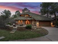 Stunning home exterior with unique roof design, landscaped yard, and charming stone accents create inviting curb appeal at 4406 Orofino Pl, Castle Rock, CO 80108