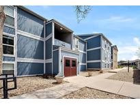 Attractive blue and white two-story home featuring landscaped yard and walkway to the front door at 7346 S Xenia Cir # A, Centennial, CO 80112