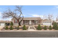 Charming home with well-maintained yard, mature trees, and a detached two-car garage at 2960 S Kearney St, Denver, CO 80222