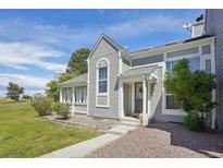Charming home featuring unique shingle siding, a covered porch, and a well-maintained front yard at 10711 Longs Way, Parker, CO 80138