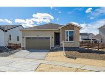 Charming single-story home featuring a two-car garage, landscaped yard, and a welcoming front entrance at 1300 Sienna Peak Cir, Erie, CO 80516