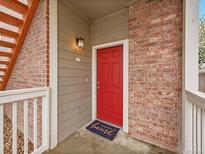 Inviting front door with brick surround and covered porch entry at 16366 E Fremont Ave # 3, Aurora, CO 80016