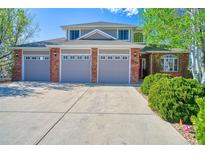 Charming two-story home featuring a three-car garage, brick accents, and well-maintained landscaping at 6800 Saddleback Ave, Firestone, CO 80504