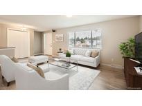 Bright living room features a large window, plush seating, and modern decor at 9014 W Harvard Dr, Lakewood, CO 80227