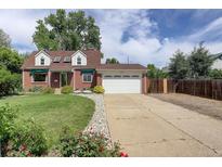 Charming brick home featuring a well-manicured lawn and a two-car garage at 4416 Brentwood St, Wheat Ridge, CO 80033