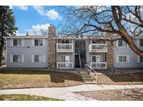 Inviting condo exterior featuring balconies, stone accents, and well-maintained landscaping for a charming curb appeal at 13241 E Asbury Dr # 203, Aurora, CO 80014