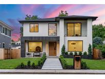 Stunning two-story modern home with a manicured lawn, sleek walkway, and stylish architectural details at 1518 S Columbine St, Denver, CO 80210