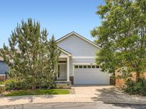 Charming single-Gathering home with a two-car garage, light-blue siding, and well-maintained landscaping at 625 Kendall Way, Lakewood, CO 80214
