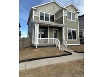 Charming two-story home with a welcoming front porch and well-lit windows at 203 Washington St, Erie, CO 80516