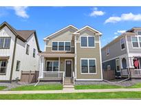 Charming two-story home with a welcoming front porch and well-maintained lawn and pleasant curb appeal at 203 Washington St, Erie, CO 80516