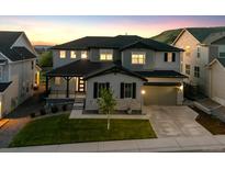 Beautiful two-story home featuring a well-maintained lawn, gray siding, and a two car garage at 359 Rogers Way, Castle Rock, CO 80104