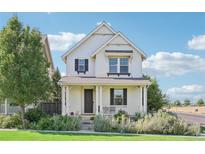 Charming two-story house with white siding, landscaping, and a front porch at 7902 E 49Th Pl, Denver, CO 80238