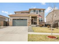 Charming two-story home with a well-maintained front yard and a welcoming entrance, including a two car garage at 18189 House Finch Ln, Parker, CO 80134