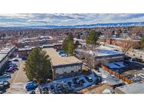 Aerial view of a multi-unit building with ample parking and mountain views at 4653 S Lowell Blvd # B, Denver, CO 80236