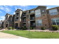 Beautiful condo complex with stone accents, balconies, and well-maintained landscaping at 3155 Blue Sky Cir # 16-103, Erie, CO 80516